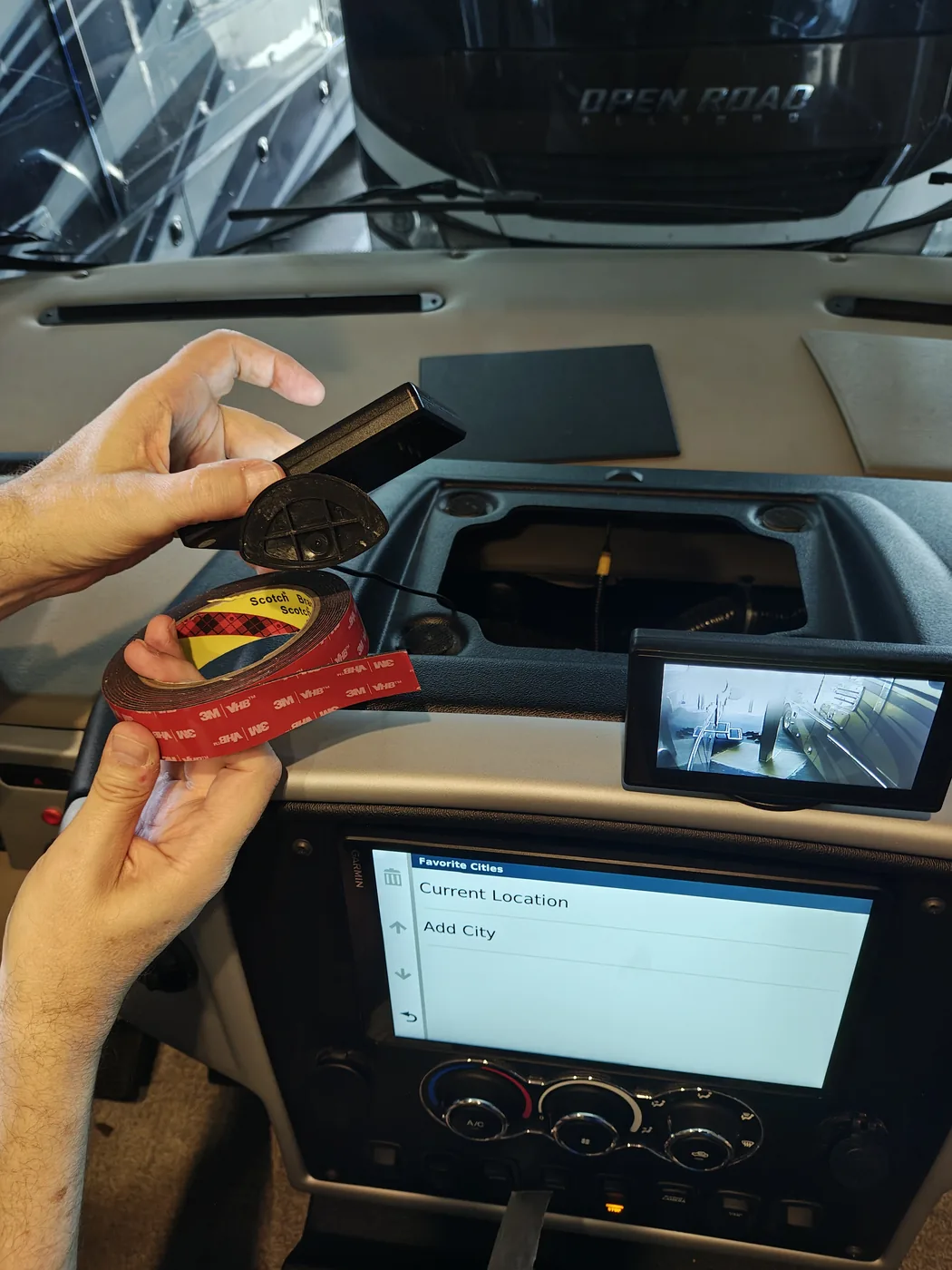 Applying 3M VHB adhesive tape to the bases of the side camera monitors
