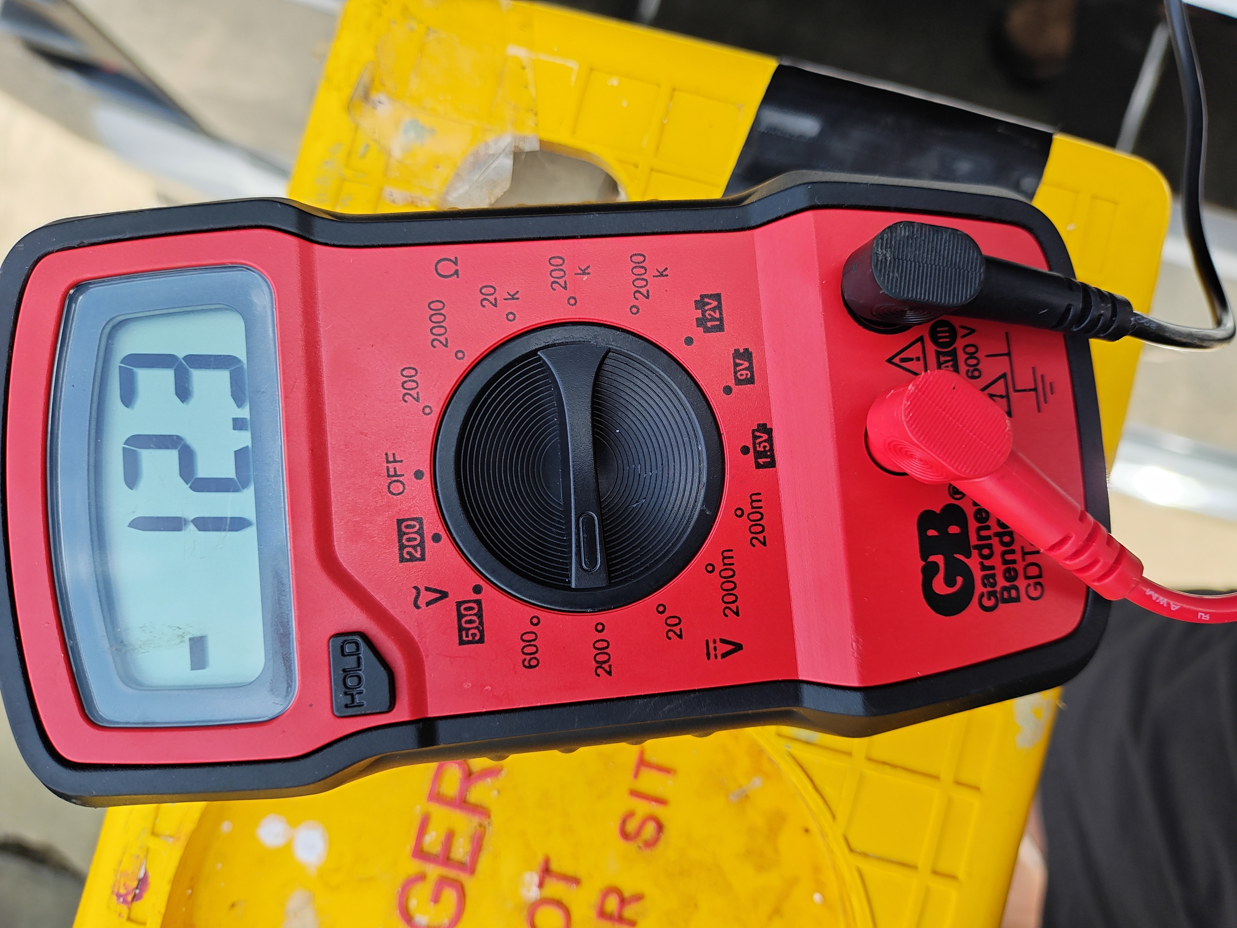 Multimeter used while testing voltage on the marker-light camera power circuit